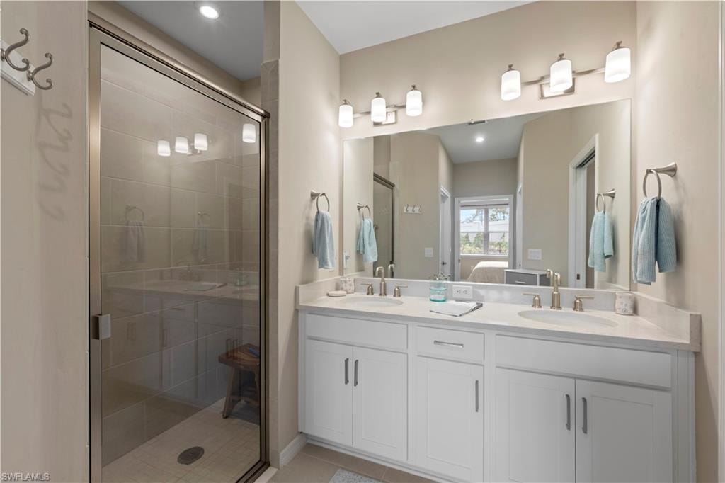 Light-toned countertops, and brushed nickel fixtures