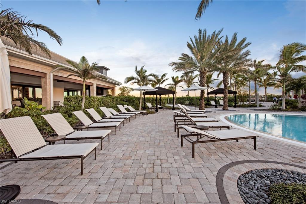 Expansive paver patio surrounding a custom-shaped swimming pool