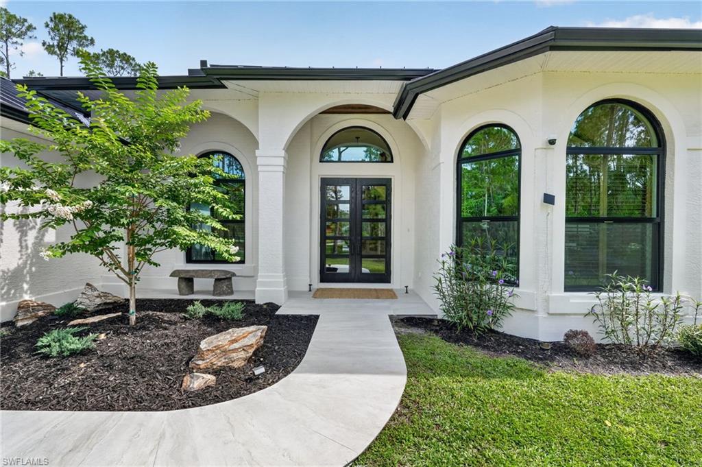 Contemporary exterior featuring a curved walkway and arched windows
