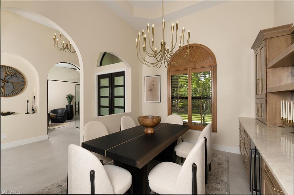 Dining space with vaulted ceiling and brass chandelier