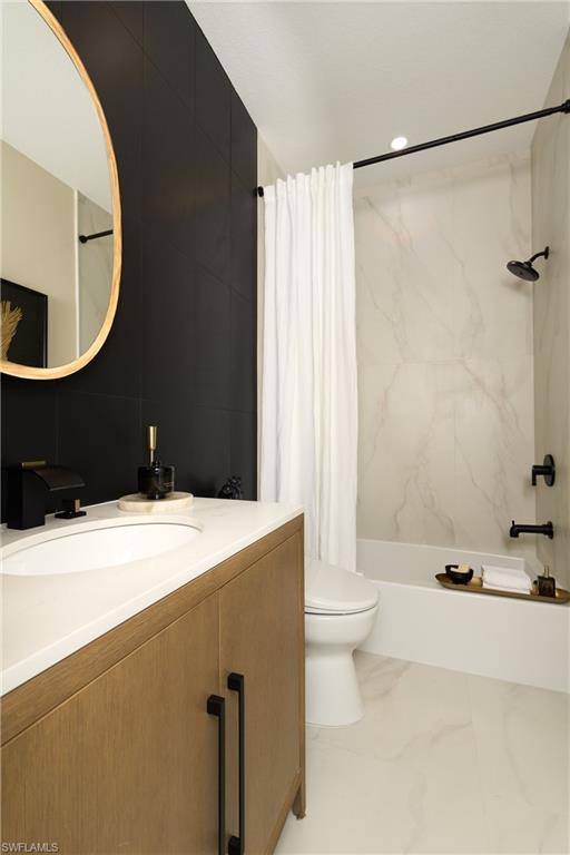 Contemporary bathroom featuring a wood-finish vanity with a white countertop and integrated sink