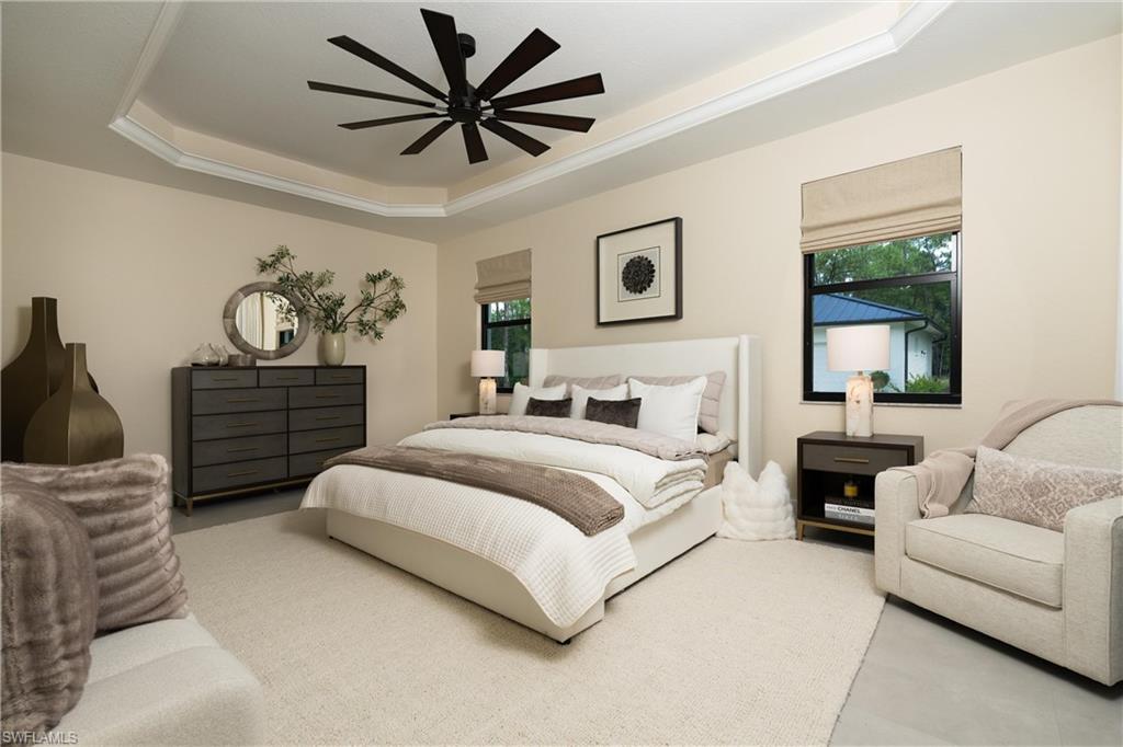 Tray ceiling with crown molding and a multi-blade ceiling fan