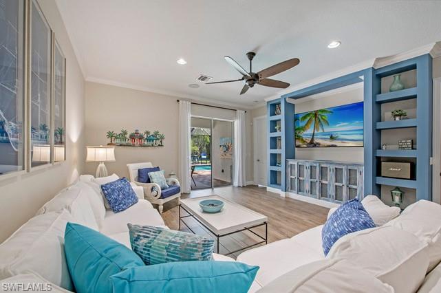 Living area featuring wood-finish flooring, recessed lighting, and a ceiling fan