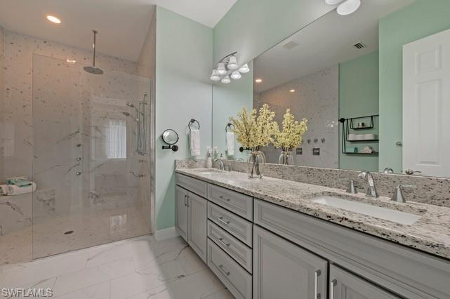 Expansive walk-in shower with a rain shower head and multiple body sprays