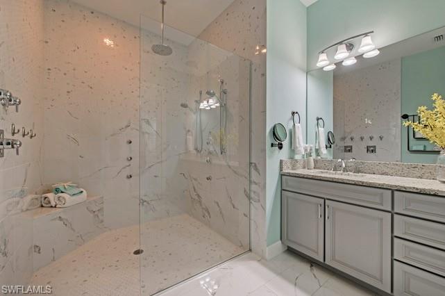 Spacious walk-in shower with full-height tile surround, built-in bench, and multiple shower heads