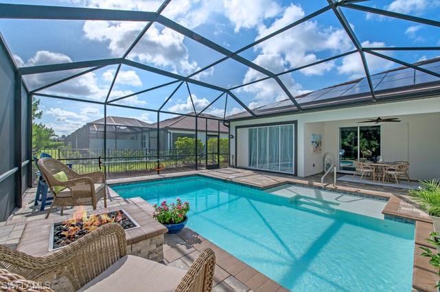 Screened enclosure surrounding a custom swimming pool with integrated sun shelf