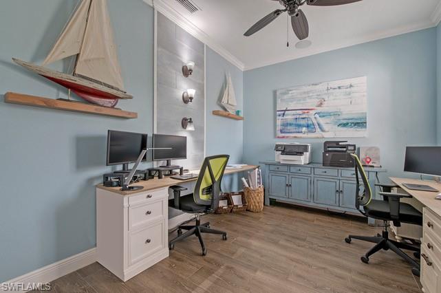 Dedicated office space featuring wood-finish flooring and light blue wall tones
