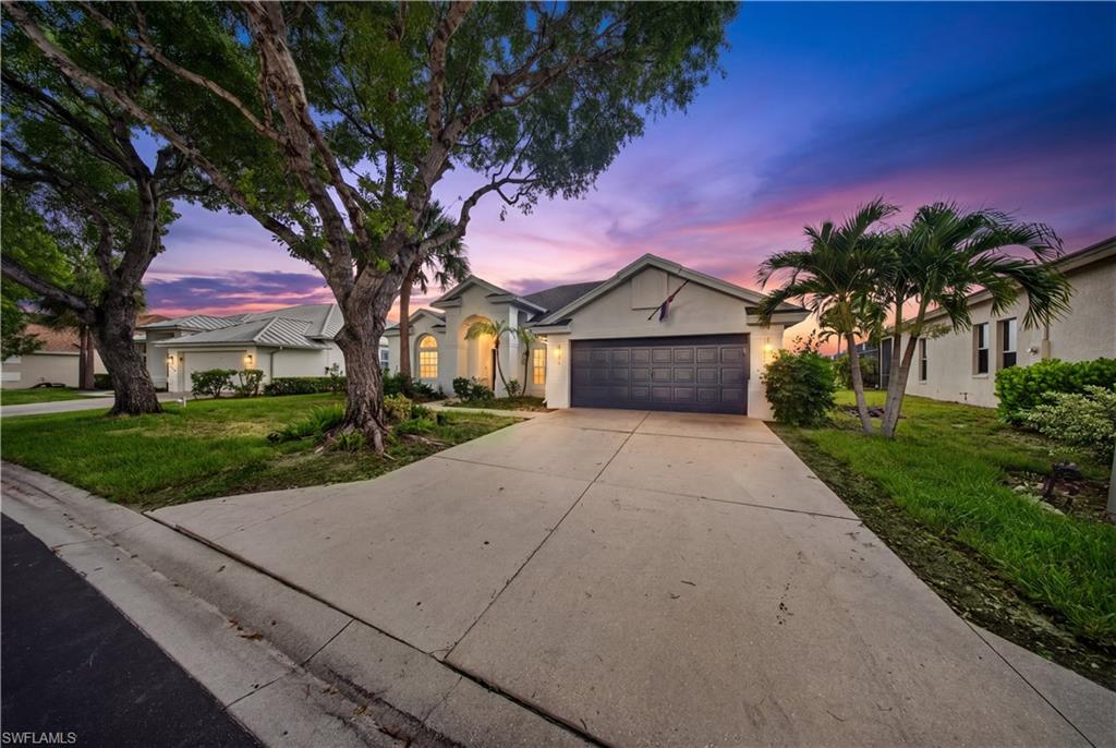 Virtual twilight image. West-facing home shown at dusk — fresh curb appeal and new LED coach lights on a quiet, newly paved street.