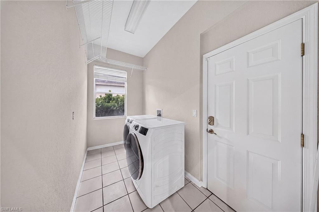 Interior laundry room with front-load washer, new utility tub and storage.