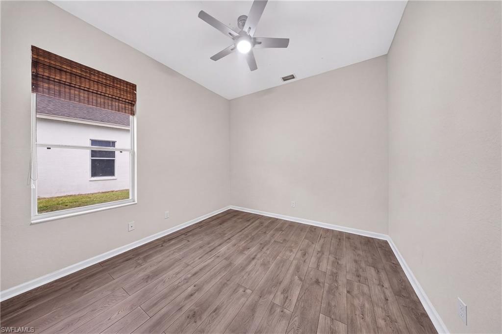 Freshly painted bedroom with all-new laminate flooring.