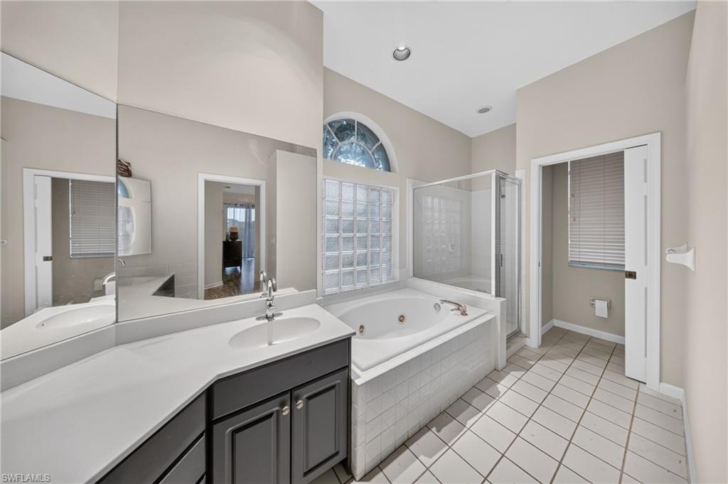 Fully-renovated primary bath: dual vanities, soaking tub, walk-in shower and designer Brizo fixtures.