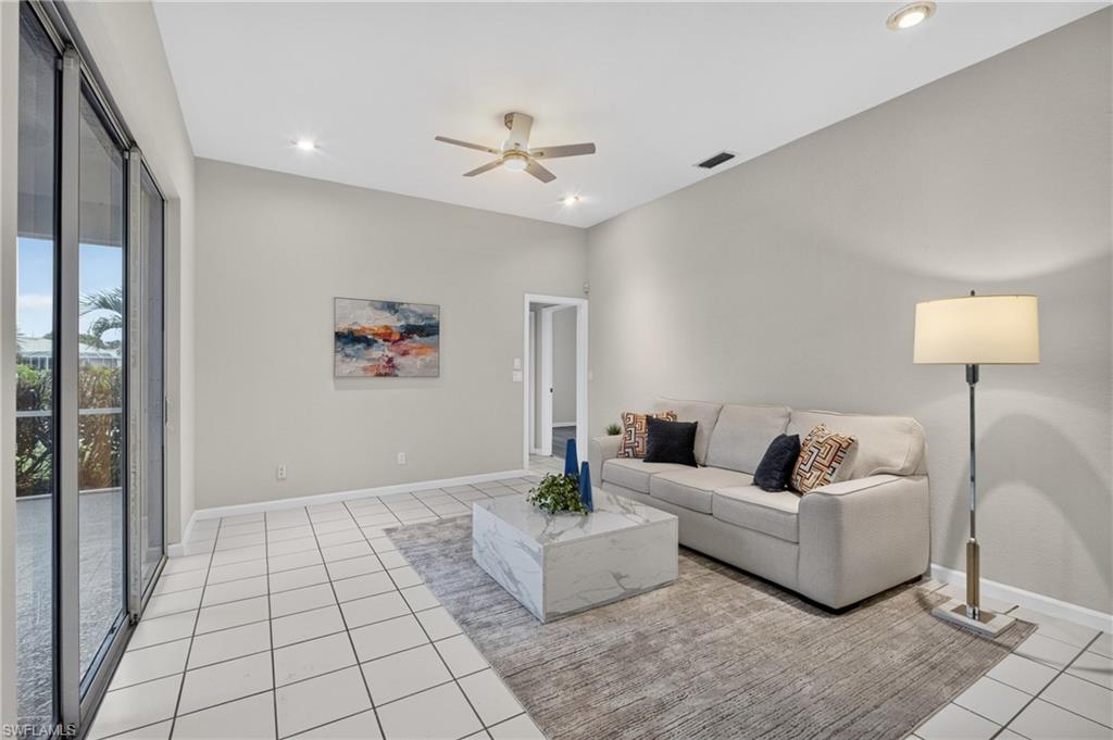 Comfortable family room with sliders to the covered, screened lanai.