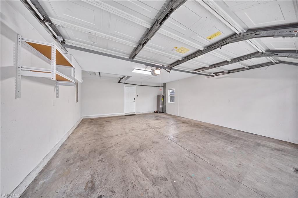 Two-car garage with new water heater (2024) and overhead storage.