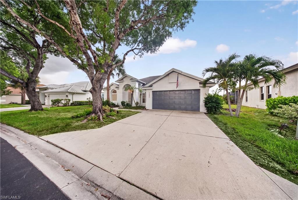 Extended driveway and 2-car garage with fresh mineral-gray paint and new LED coach lights.
