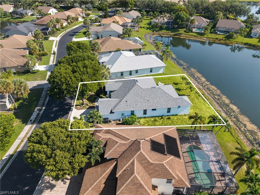 Aerial view of the home's setting along the community lake.