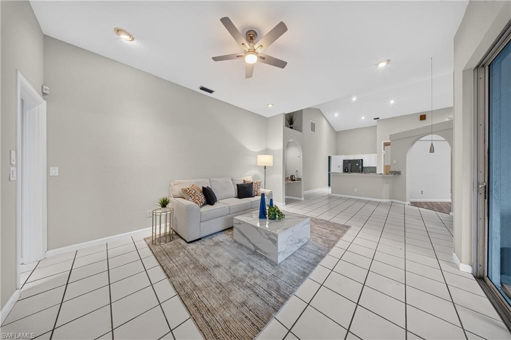 Soaring vaulted great room with all-new laminate flooring and LED dimmable lighting, flowing seamlessly to the kitchen.