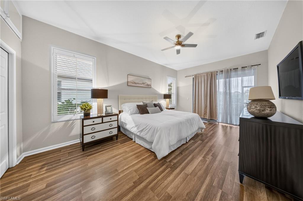 Spacious primary bedroom with pond-side light, new flooring and a new satin-nickel fan.