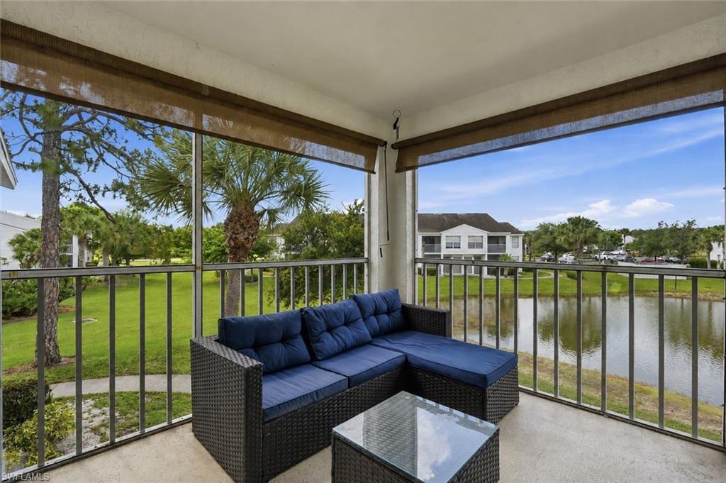 Screened balcony featuring a concrete floor and roller shades