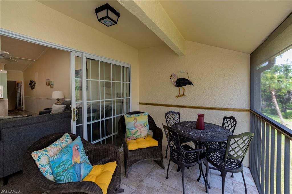 Sunroom featuring lofted ceiling with beams and ceiling fan