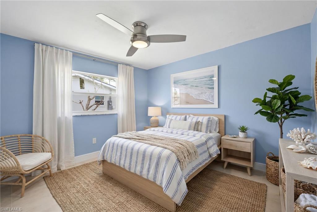 Bedroom #3 featuring light blue walls, a ceiling fan with integrated lighting, and a window with white trim