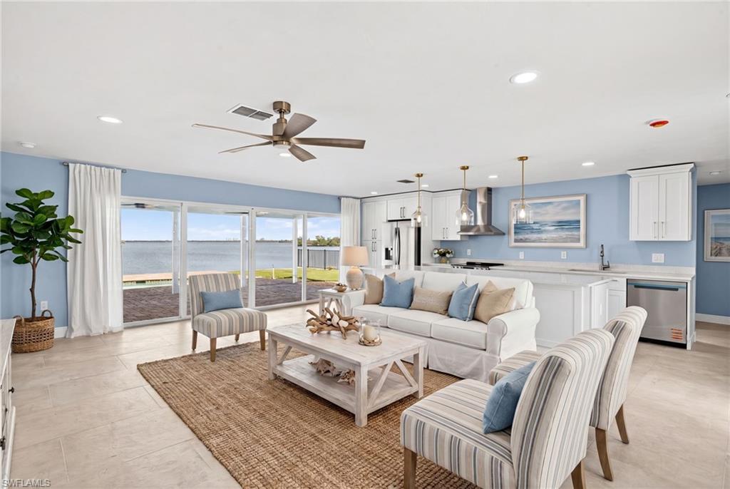Open-concept living area with a waterfront backdrop