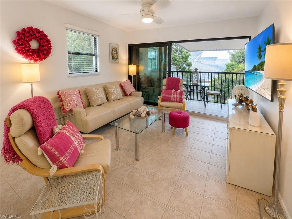 Living space featuring tile flooring and a ceiling fan