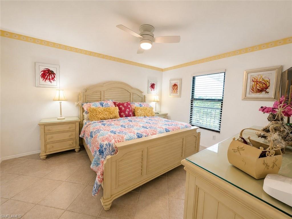Spacious room featuring tile flooring, a window with horizontal blinds, and a ceiling fan with integrated lighting