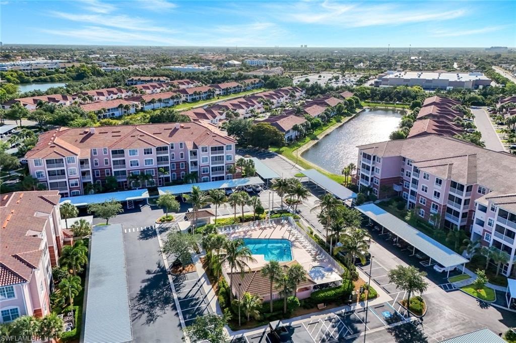 Aerial perspective showcasing a community with multiple multi-story buildings featuring balconies and red tile roofs