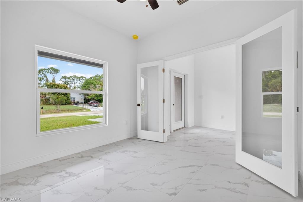 Cozy den or home office featuring a stylish double-door entrance.