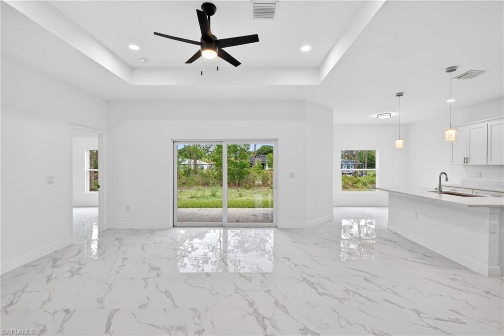 Tray ceilings paired with modern floors create a stylish and contemporary look.