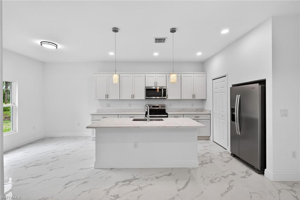 Sleek lighting and modern stainless steel appliances