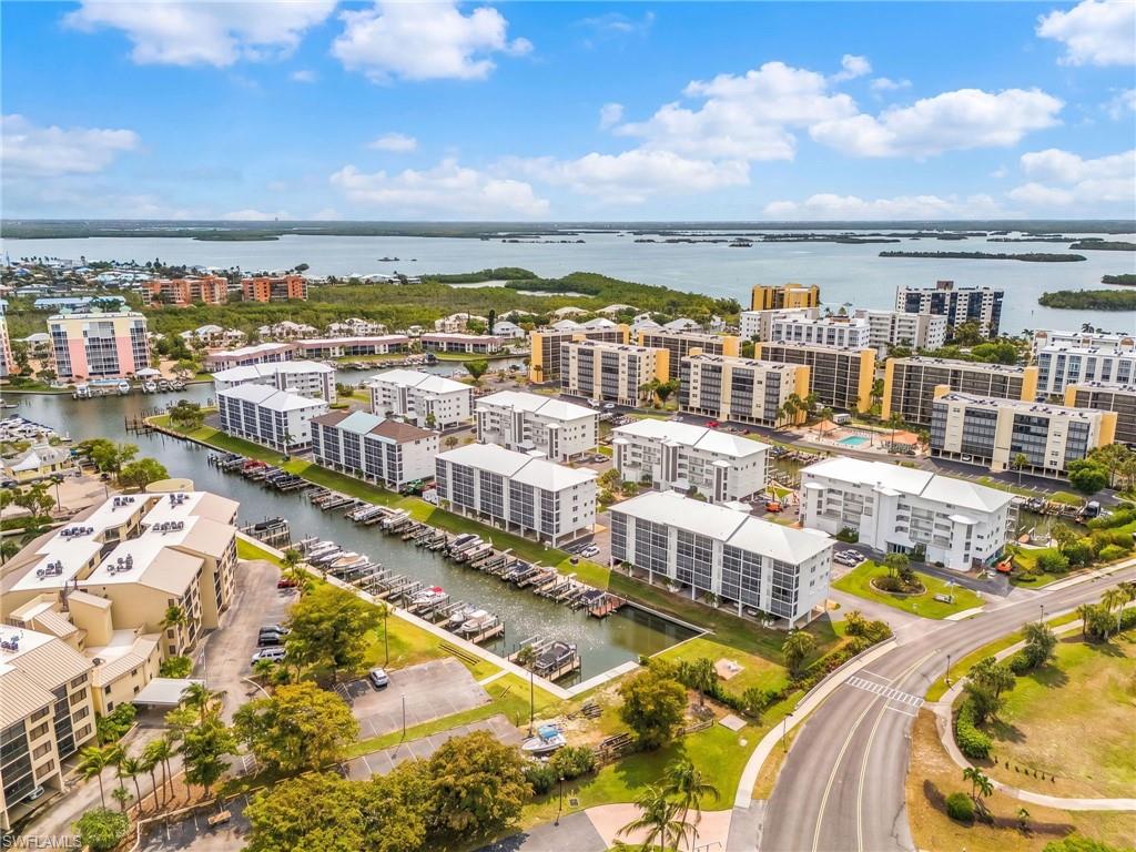 Aerial perspective showcasing multiple waterfront condominium buildings with private boat slips