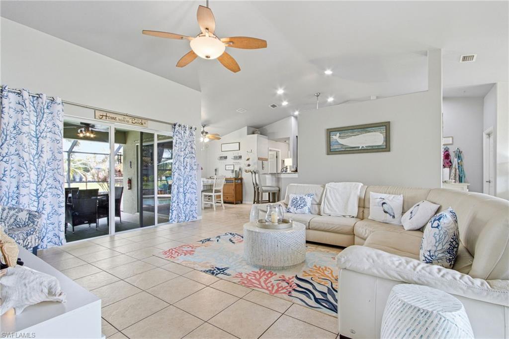 Spacious living area featuring vaulted ceilings, tile flooring, and recessed lighting