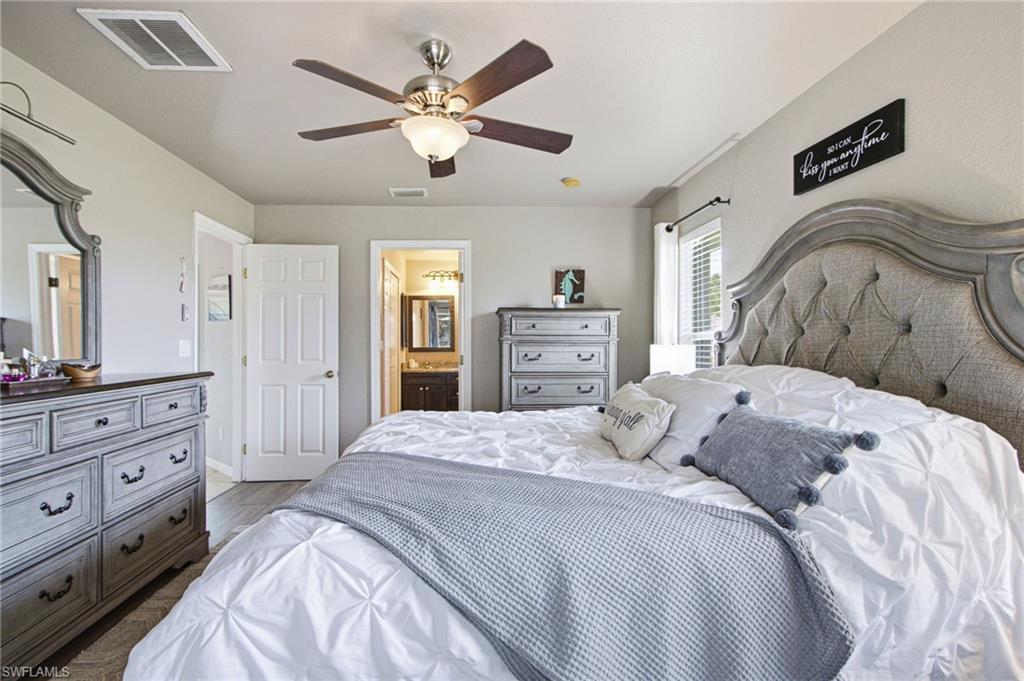 Neutral wall tones complement the wood-finish flooring