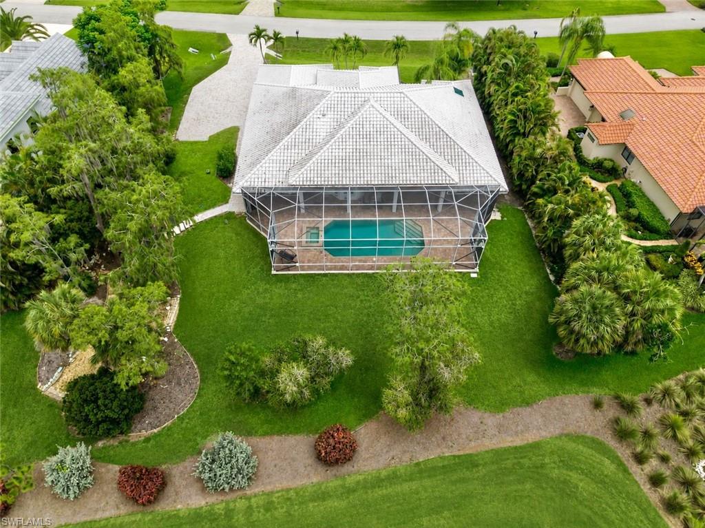 Aerial view showcasing one of Fiddlesticks' most unique homesites, where expansive green space, mature tropical landscaping, and generous separation from neighboring properties create an exceptional level of privacy rarely found on a golf course lot.