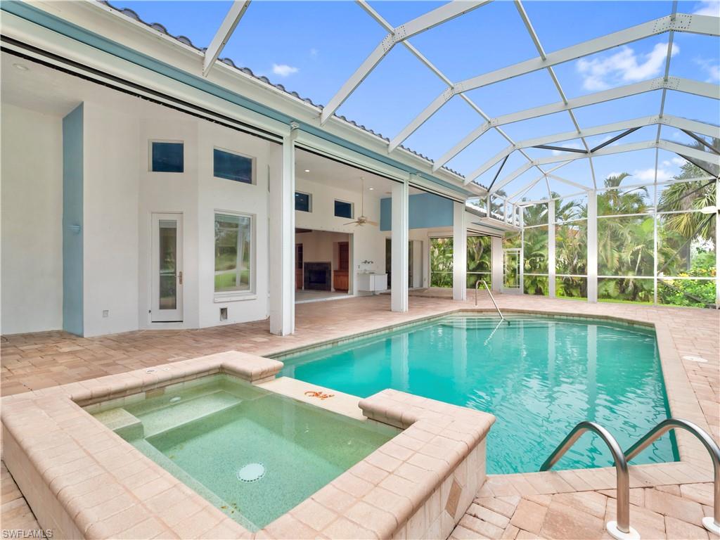 Designed for entertaining, the pool and spa area features expansive paver decking, covered gathering spaces, and seamless access to the main living areas through pocket sliders.