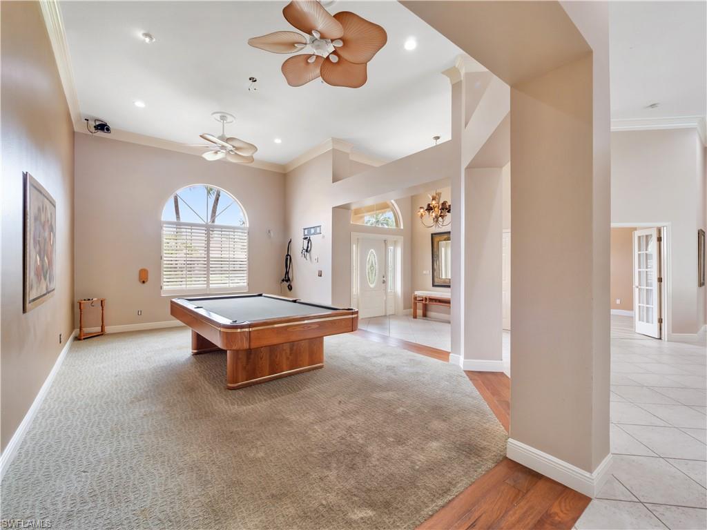 Generously sized flex space with soaring ceilings and abundant natural light, ideal as a billiards room, formal dining area, or entertainment space.