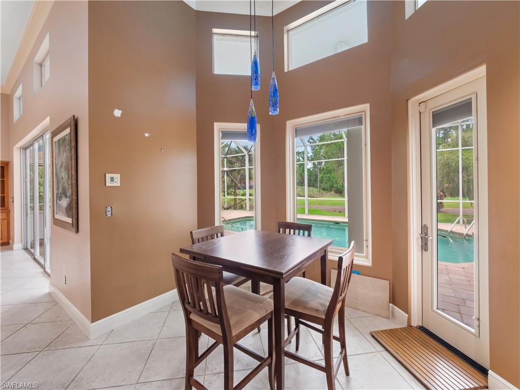 The breakfast nook captures the essence of Florida living with pool views, natural light, and easy access to the screened lanai.