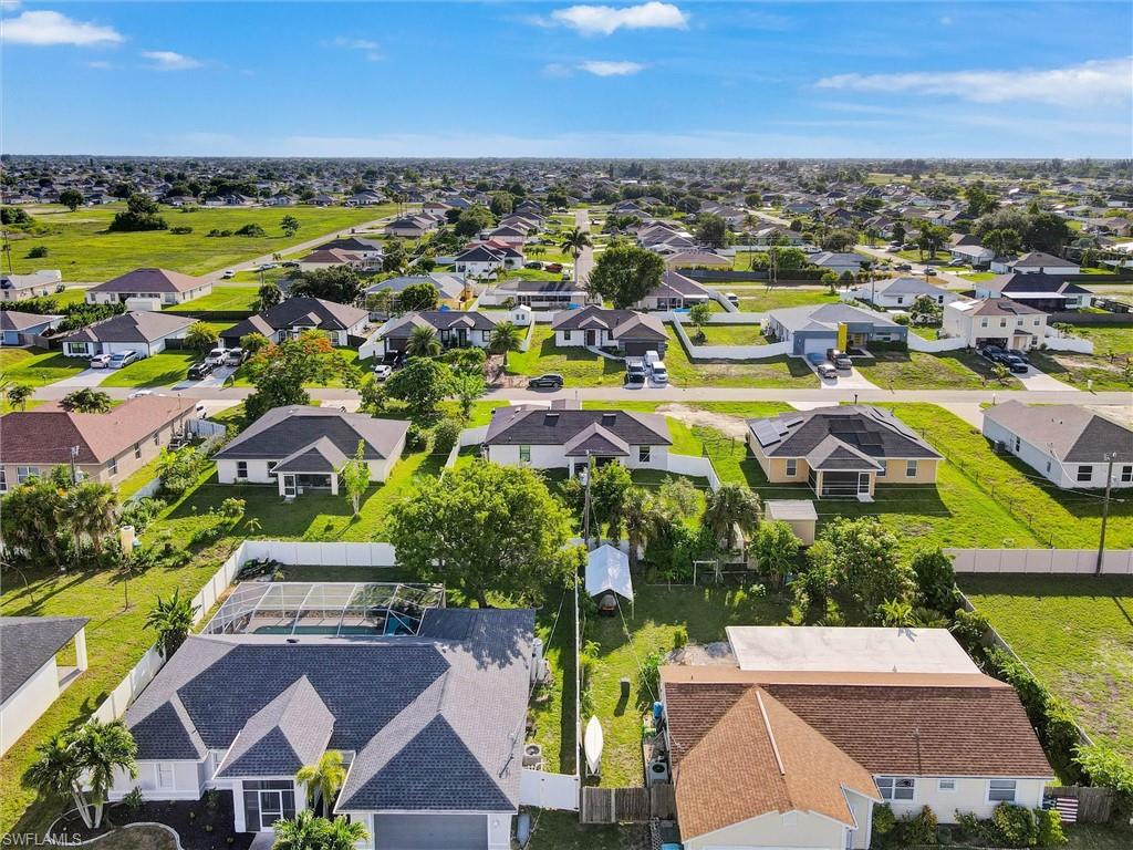 Expansive neighborhood setting featuring numerous single-story properties with diverse rooflines and mature landscaping