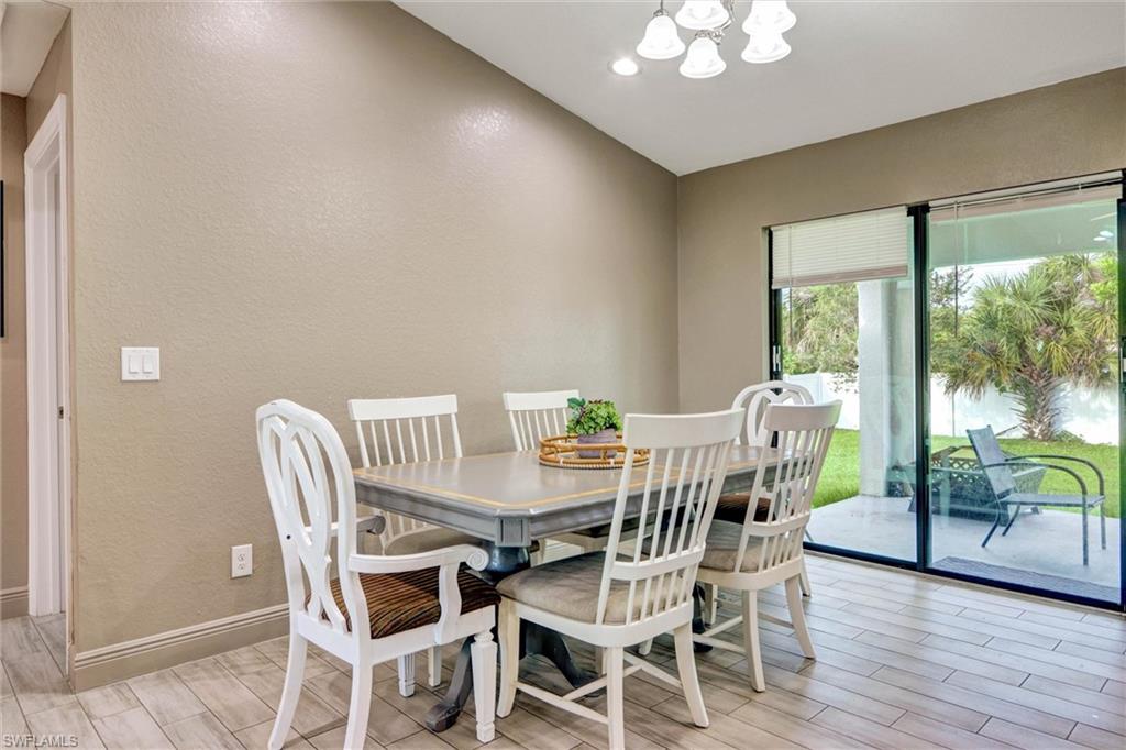 Dining area featuring wood-finish flooring, neutral wall tones, and a multi-light ceiling fixture