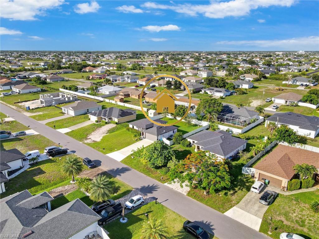 Aerial perspective showcasing a residential neighborhood with single-story homes and undeveloped lots
