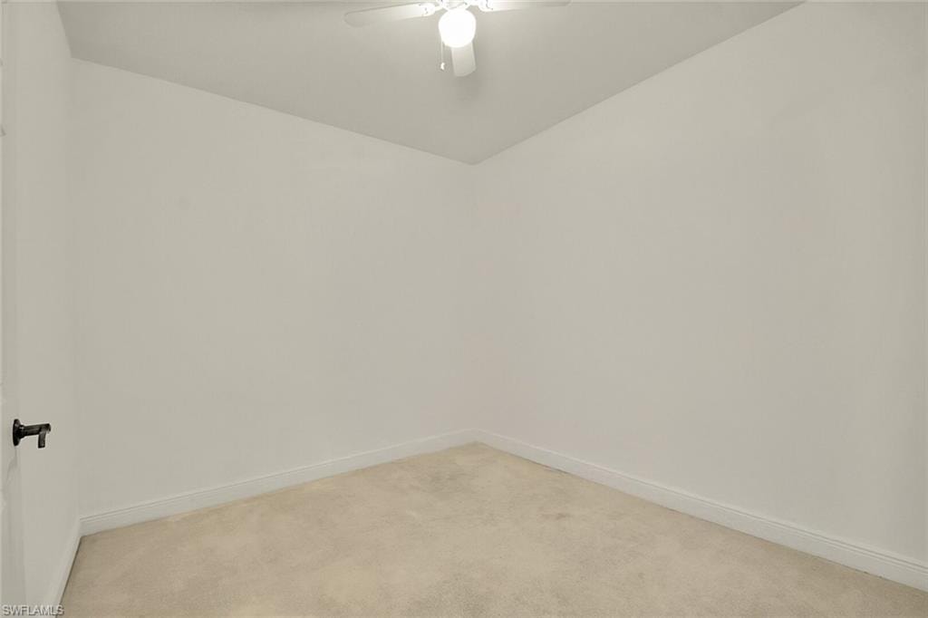 Empty room with carpet and ceiling fan