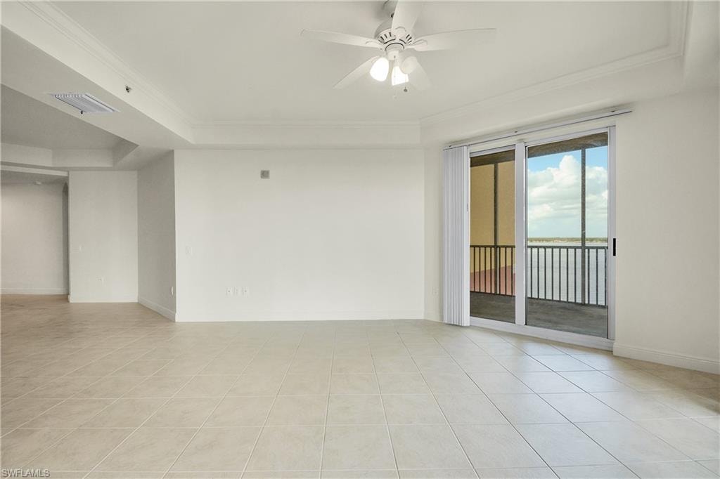 Unfurnished room featuring light tile patterned floors, ceiling fan, and ornamental molding