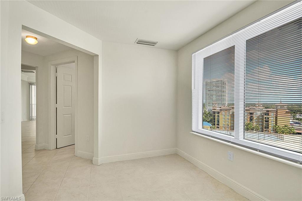 Empty room with baseboards and light tile patterned floors