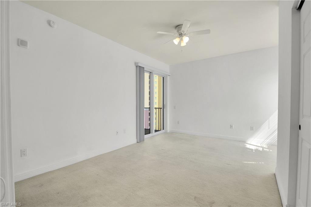 Spare room with light colored carpet and a ceiling fan