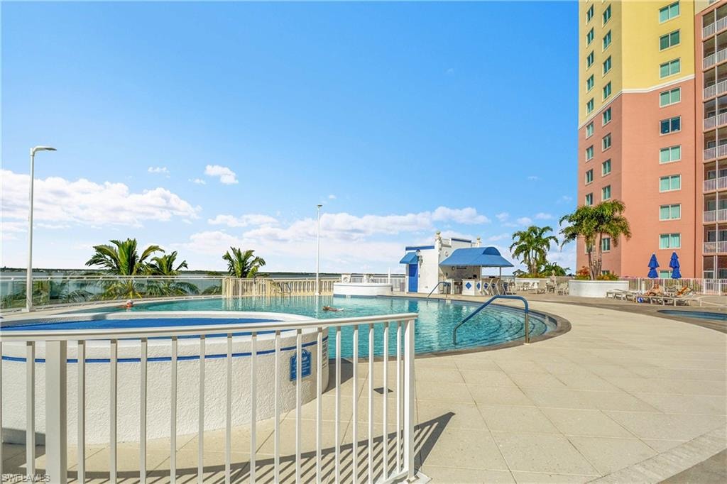 Community pool with a patio