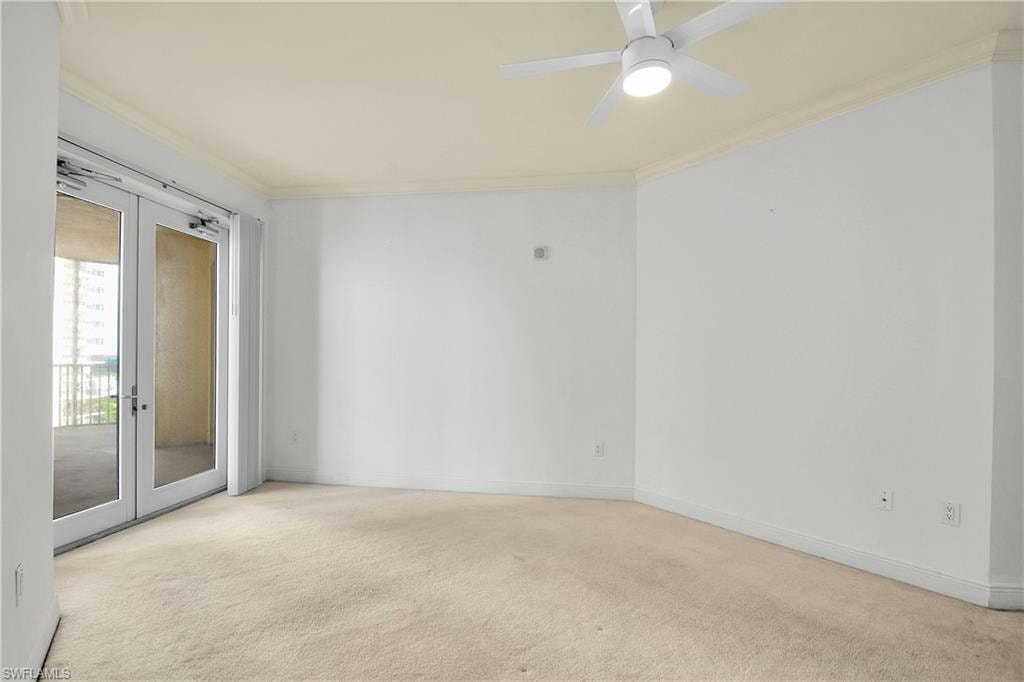 Spare room with ornamental molding, light colored carpet, french doors, and ceiling fan