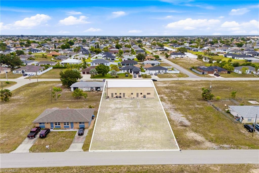 Bird's-eye view showcasing the commercial property and the additional parcel included in the sale, highlighting the unique two-parcel opportunity and future development potential.