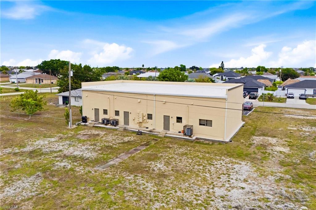 Rear view of the property showcasing the additional space and flexibility offered by this unique two-parcel commercial opportunity.