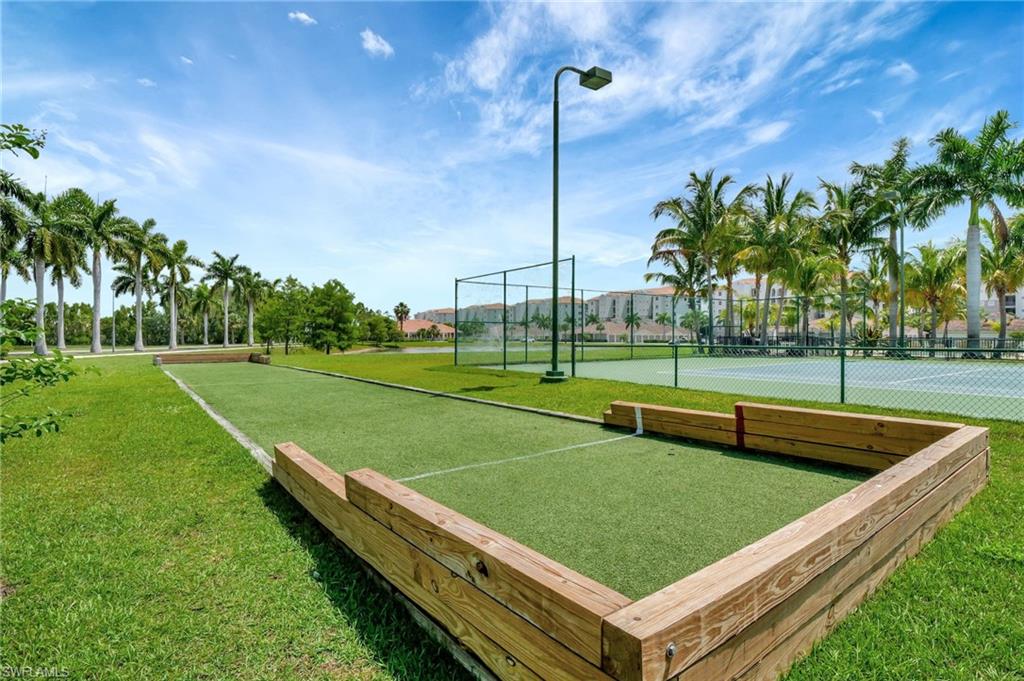 Bocce ball court featuring wood-finish borders and artificial turf surface